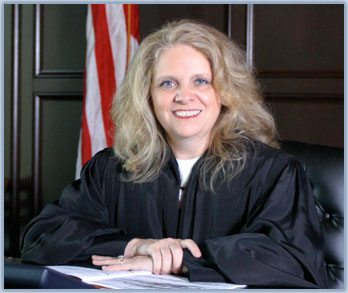 Photo of Judge Martha Geer sitting on the bench in her courtroom